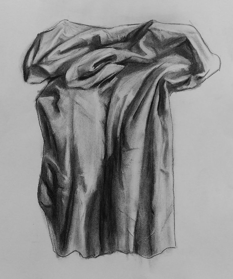 Charcoal drawing on coarse paper of cloth, lazily piled and hanging partially over an edge.