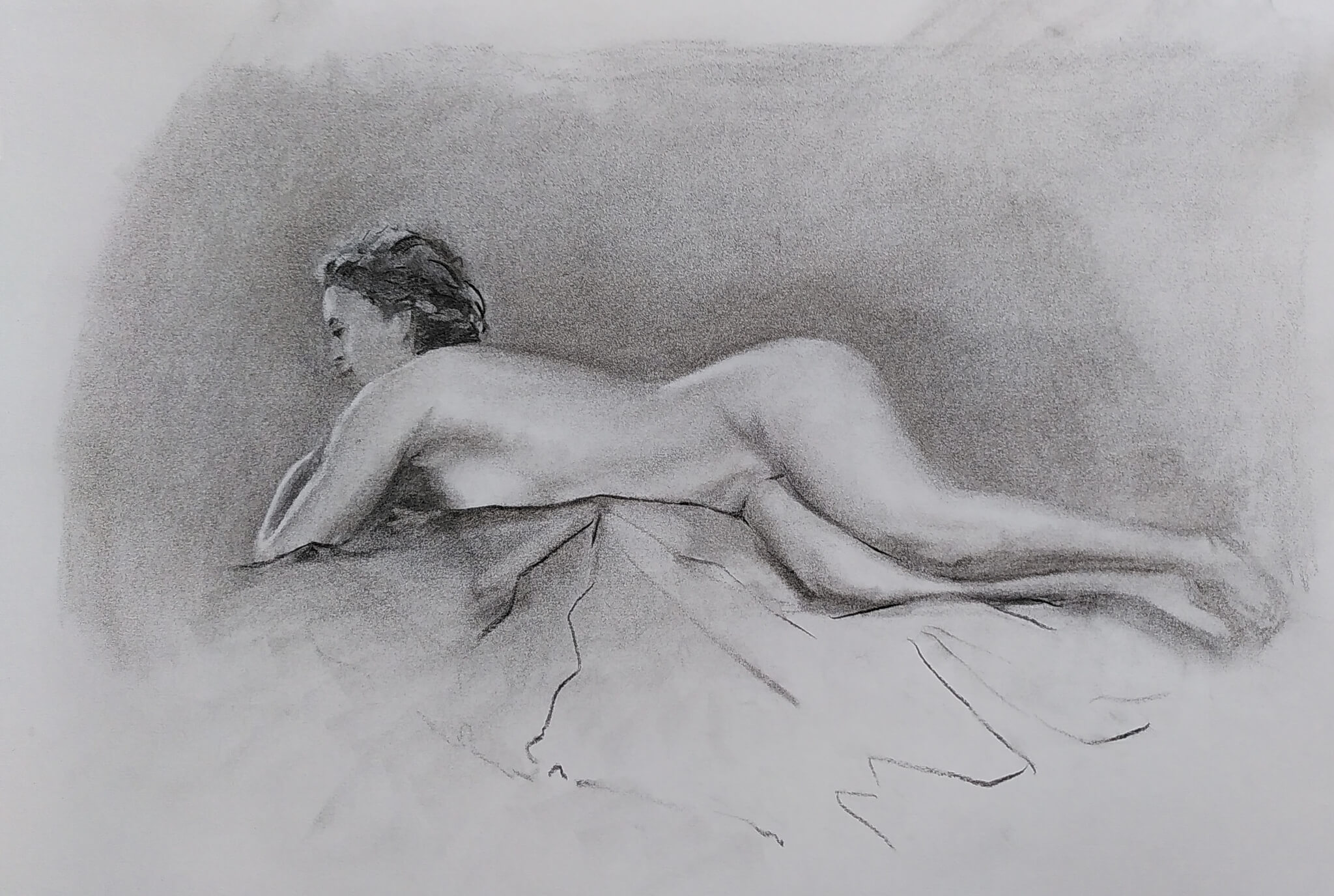 Charcoal nude of a recumbent woman.